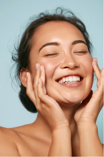 woman touching her face, smiling
